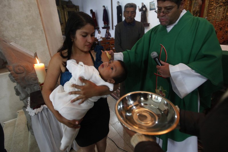 A child is pictured in a file photo being baptized at a church in Mexico City. The apostolic nuncio to Mexico has warned the country's bishops to "look reality in the eye" as the country's non-Catholic population increases and Mexicans increasingly identify as nonreligious. (CNS photo/Edgard Garrido, Reuters)