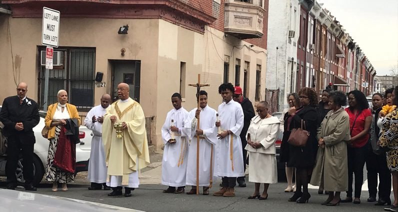 Father Stephen Thorne, pastor of St. Martin de Porres Parish in Philadelphia, blesses the location where a murder took place outside the church hours after the Easter Vigil Mass, April 21, 2019. (CNS photo/Father Stephen Thorne, courtesy photo via CatholicPhilly.com)