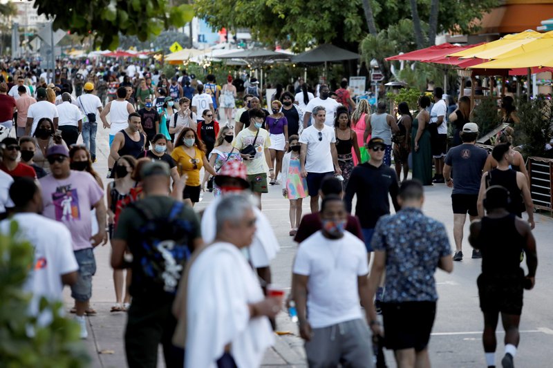 A large crowd walks along Ocean Drive during spring break festivities in Miami Beach March 5, 2021, during the COVID-19 pandemic. (CNS photo/Marco Bello, Reuters)