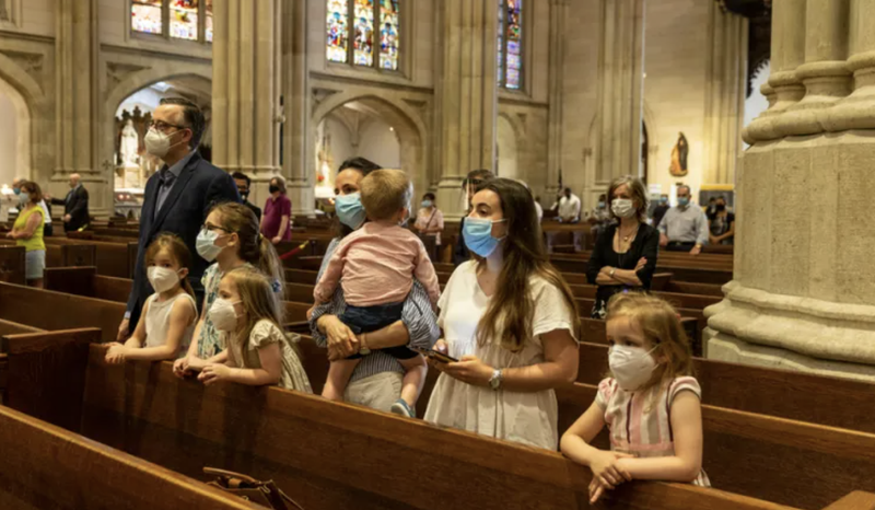 A family prays at St. Patrick's Cathedral in New York City, June 2020. (lev radin/Shutterstock)