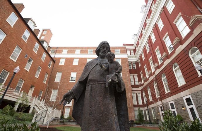 Isaac Hawkins Hall is seen on the campus of Georgetown University April 4, 2017. The hall, previously known as Mulledy Hall and later Freedom Hall, was renamed in 2017 for one of the 272 enslaved men, women and children sold by Georgetown's Jesuit community to plantation owners in Louisiana in 1838. Hawkins was the first enslaved person listed in the sale documents. (Tyler Orsburn/CNS)