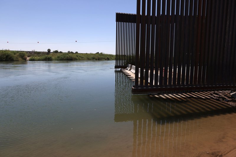 The Colorado River flows past the border wall in Andrade, Calif., April 19, 2021. The Biden administration canceled former President Donald Trump's border wall projects April 30 paid for with funds diverted from Defense Department accounts. (CNS photo/Jim Urquhart, Reuters)
