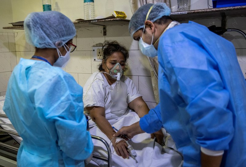 Rohan Aggarwal, 26, a resident doctor treating patients suffering from COVID-19, tends to a patient inside the emergency room of Holy Family Hospital during his 27-hour shift in New Delhi, India, May 1, 2021. As India faces a massive surge in new infections and deaths caused by COVID-19, Pope Francis said he was praying for all those affected by the huge health emergency. (CNS photo/Danish Siddiqui, Reuters)