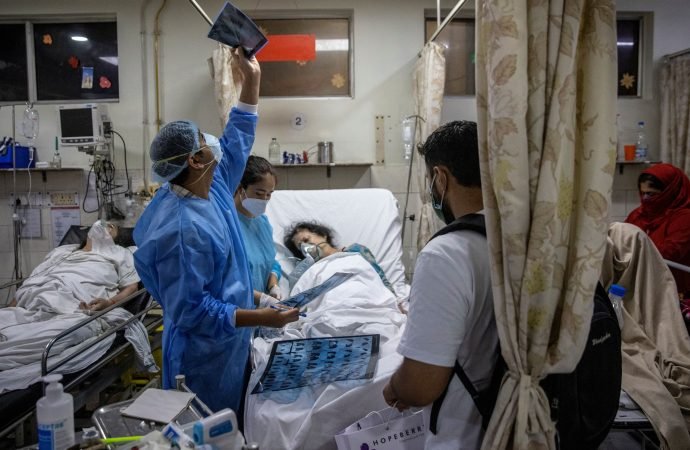 Rohan Aggarwal, 26, a resident doctor treating patients suffering from COVID-19, looks at a patient's X-ray scan, inside the emergency room of Holy Family Hospital, during his 27-hour shift in New Delhi May 1, 2021. As India faces a massive surge in new infections and deaths caused by COVID-19, Pope Francis said he was praying for all those affected by the huge health emergency. (Danish Siddiqui/Reuters, via CNS)