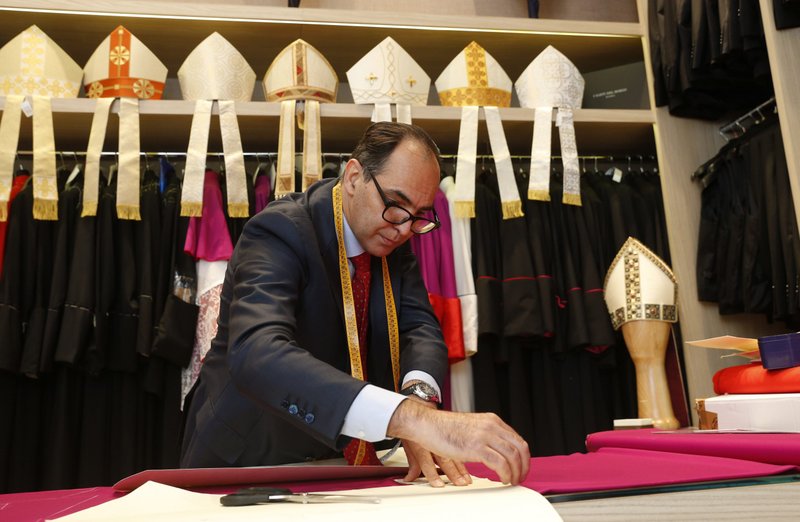 Ety Cicioni, a tailor who produces uniforms for the Swiss Guard and clerical wear, works on a garment in his shop near the Vatican in Rome April 29, 2021. Several Rome-based artisans who work in the Catholic sphere indicated that even if the pandemic were to disappear in a miraculous instant, the traditional trades still face an uphill struggle to stay profitable. (CNS photo/Paul Haring)