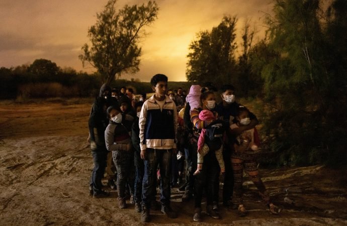 Migrants from Central America seeking asylum in the U.S. line up to be escorted to the main road by the Texas Army National Guard in Roma, Texas, after crossing the Rio Grande May 15, 2021. (CNS photo/Adrees Latif, Reuters)