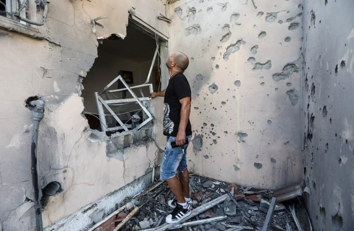Amir Buchbut looks at his damaged house after it was hit with a rocket fired from Gaza to Sderot, Israel, May 20, 2021. (Baz Ratner/Reuters via CNS)