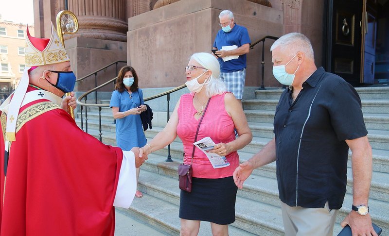 Philadelphia Archbishop Nelson J. Pérez greets worshippers after Mass May 23, 2021, outside the Cathedral Basilica of SS. Peter and Paul. He announced a major new initiative by the Philadelphia Archdiocese to invite Catholics back to in-person participation in the Mass at their parishes as COVID-19 restrictions on gatherings begin to lift. (CNS photo/Sarah Webb, CatholicPhilly.com)