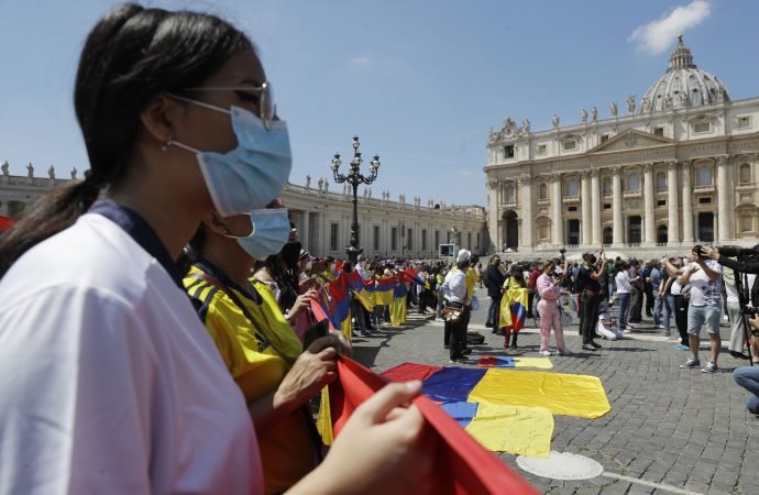 Faithful hold Colombian flags as they listen to Pope Francis Angelus reciting the noon prayer in St. Peter's Square at the Vatican, Sunday, May 9, 2021. (Gregorio Borgia/AP via Crux)