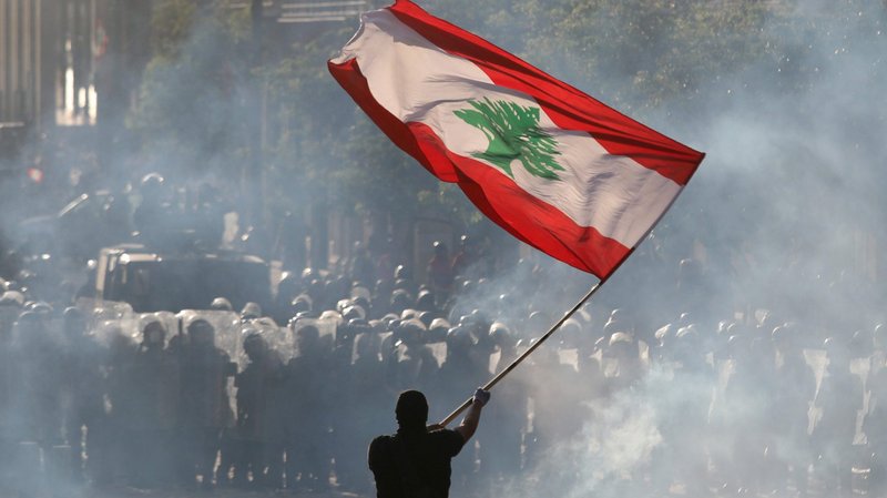 An anti-government protesters waves a Lebanese flag during clashes with security forces in Beirut Aug. 8, 2020. (Goran Tomasevic/Reuters/CNS via Crux)