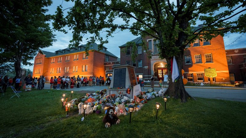 Kamloops residents and First Nations people gather to listen to drummers and singers at a memorial in front of the former Kamloops Indian Residential School in British Columbia May 31, 2021. Indigenous leaders and residential school survivors in Canada are calling on officials to conduct a thorough investigation of every former residential school in the country after the remains of more than 200 children were found on the grounds of the former Kamloops Indian Residential School. (CNS photo/Dennis Owen, Reuters)