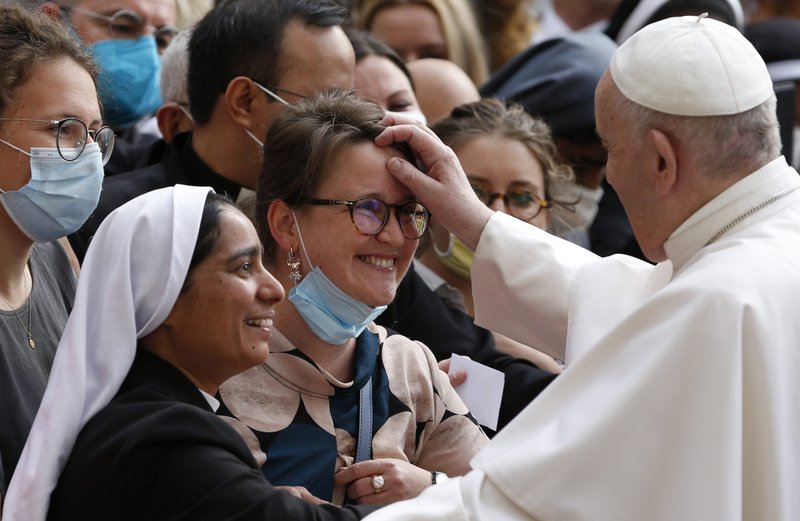 Pope Francis greets a woman during his general audience in the San Damaso Courtyard of the Apostolic Palace at the Vatican June 2, 2021. (CNS photo/Paul Haring)