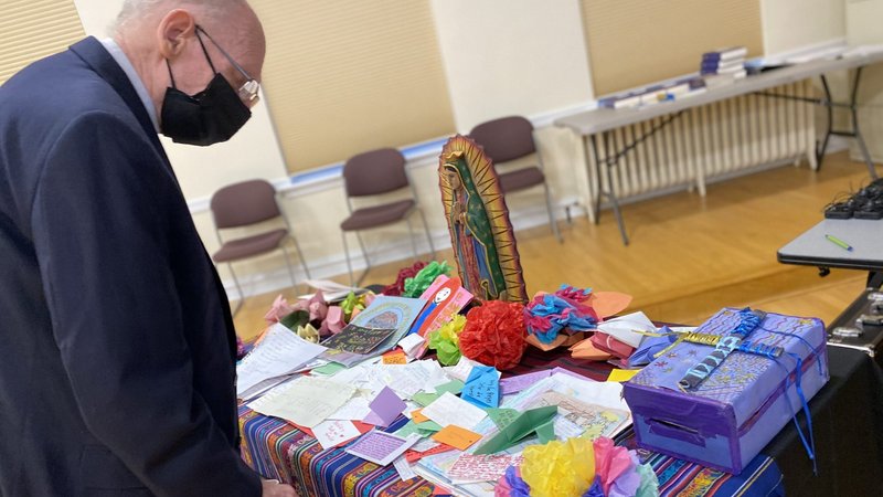 Bishop Guido Charbonneau of Honduras looks at notes written by children in detention camps during a break June 1, 2021, at Mundelein Seminary outside of Chicago. Along with other bishops from Central America and Mexico, he was participating in an emergency meeting June 1, 2 at the urging of U.S. bishops to address immigration. (CNS photo/Rhina Guidos)
