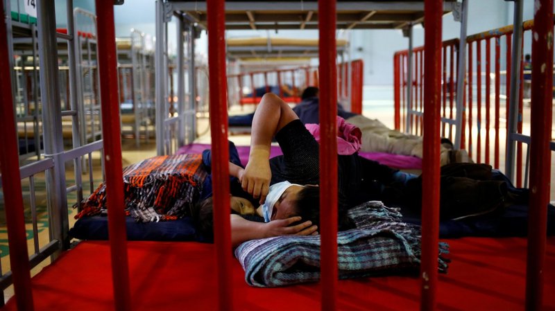 A migrant from Central America who was airlifted from Brownsville, Texas, to El Paso, Texas, and then deported with her son are seen at a temporary temporary shelter in Ciudad Juarez, Mexico, April 5, 2021. (CNS photo/Jose Luis Gonzalez, Reuters)