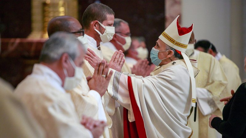 Cardinal Daniel N. DiNardo of Galveston-Houston greets newly ordained Deacon Bruce Flagg during an ordination Mass for permanent deacons at the Co-Cathedral of the Sacred Heart in Houston Feb. 20, 2021. Deacon Flagg, who is deaf, assists with deaf ministry in the Archdiocese of Galveston-Houston. (CNS photo/James Ramos, Texas Catholic Herald)