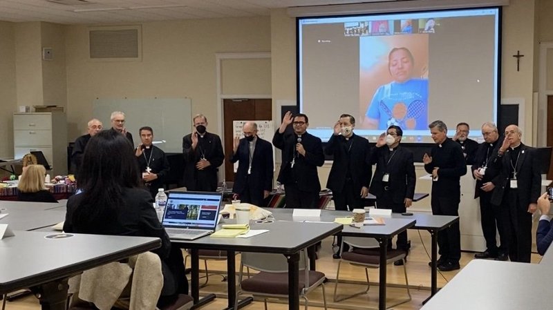 Bishops from the U.S., Central America and Mexico face the camera at the chapel of Mundelein Seminary outside of Chicago June 2, 2021, to bless a Salvadoran woman via Zoom who shared her story of immigration with them. Along with Vatican representatives and Catholic organizations, the prelates participated in an emergency session June 1 and 2 to set forth the U.S. church's response to immigration as well as to seek greater collaboration with bishops from countries where some migrants are coming from. (CNS photo/Rhina Guidos)