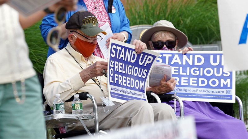 Eric and Anne Waxman recite the rosary while participating in a roadside prayer rally marking Religious Freedom Week at St. James Church in Setauket, N.Y., June 24, 2020. (CNS photo/Gregory A. Shemitz)
