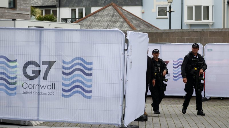 Armed police officers patrol in Falmouth, England, June 10, 2021, ahead of the G7 summit in Cornwell. Debt relief for poor countries is only way for G7 leaders to succeed in their plans to promote global recovery from the COVID-19 pandemic and address the climate crisis, Caritas Internationalis said. (CNS photo/Phil Noble, Reuters)