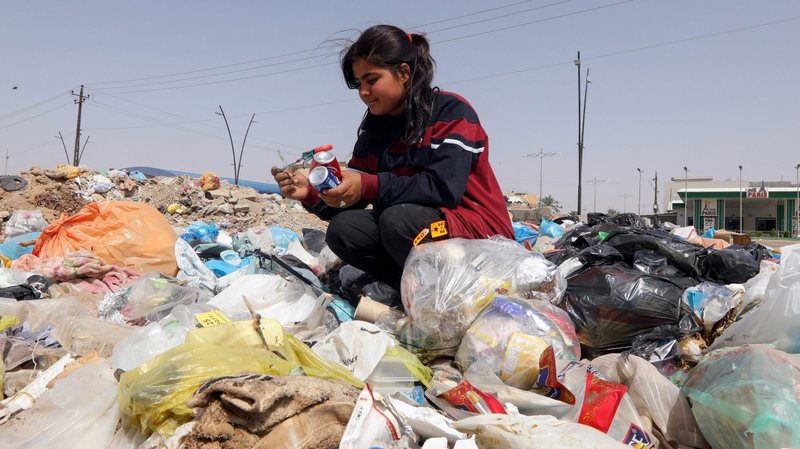 Sahar Shaaban, 11, an Iraqi girl who provides for her family, collects cans from a garbage area in Kirkuk, Iraq, April 21, 2021. (CNS photo/Ako Rasheed, Reuters)