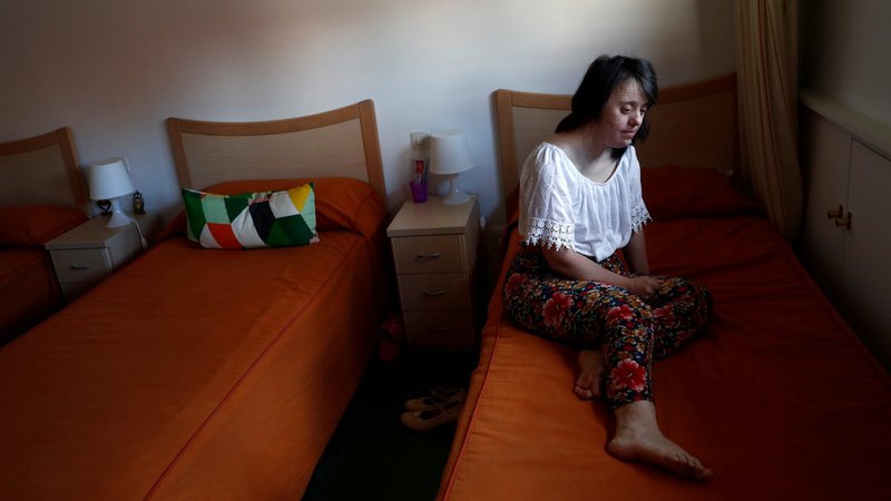Resident Dolores Gallego spends some quiet time in her bedroom at the Alas Foundation center for women with intellectual disabilities during the COVID-19 outbreak in Madrid in this June 16, 2020, file photo. The Pontifical Academy for Life has released a new document on how the pandemic has impacted people with disabilities and their caregivers. (CNS photo/Susana Vera, Reuters)