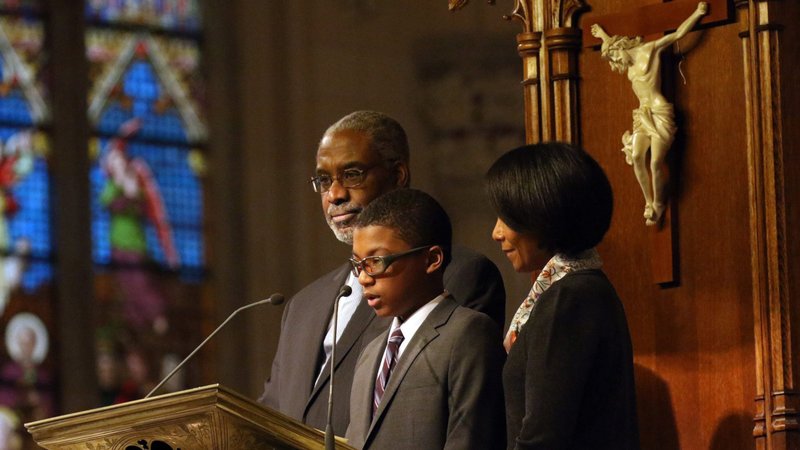 Harris Adolph is accompanied by his parents, Gerald and Gwen Adolph, as he proclaims the first reading during the annual Black History Month Mass at St. Patrick's Cathedral in New York City Feb. 4, 2018. (CNS photo/Gregory A. Shemitz)