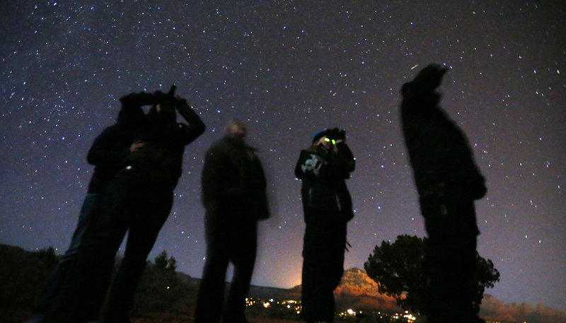 People use night vision goggles to look at the night sky during an Unidentified Flying Object (UFO) tour in the desert outside Sedona, Arizona, in this Feb. 14, 2013, file photo. With the expected release this month of the U.S. Department of Defense's report on unidentified aerial phenomenon, Catholic News Service spoke to three experts on the potential discovery of extraterrestrial life and its theological implications. (CNS photo/Mike Blake, Reuters)
