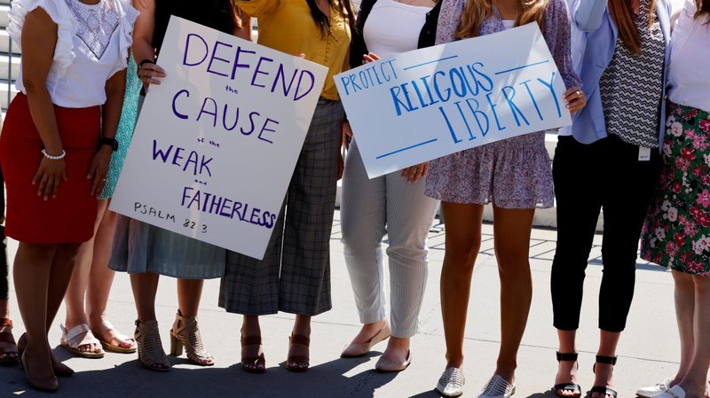 Women pose for a picture near the U.S Supreme Court building in Washington June 17, 2021. In a unanimous decision June 17, the Supreme Court said that a Catholic social service agency should not have been excluded from Philadelphia's foster care program because it did not accept same-sex couples as foster parents. (CNS photo/Jonathan Ernst, Reuters)