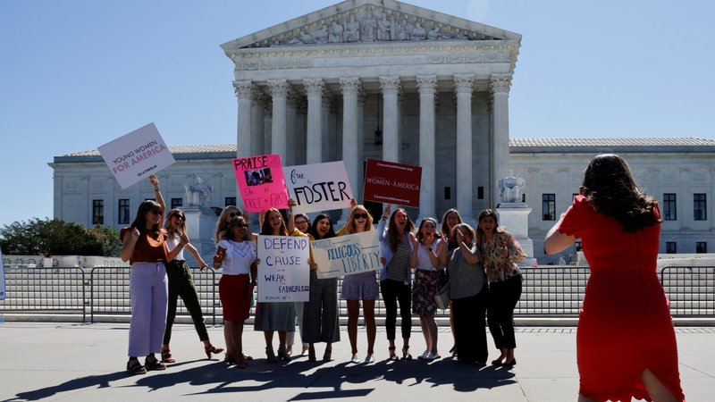 Women pose for a picture near the U.S Supreme Court building in Washington June 17, 2021. In a unanimous decision June 17, the Supreme Court said that a Catholic social service agency should not have been excluded from Philadelphia's foster care program because it did not accept same-sex couples as foster parents. (CNS photo/Jonathan Ernst, Reuters)
