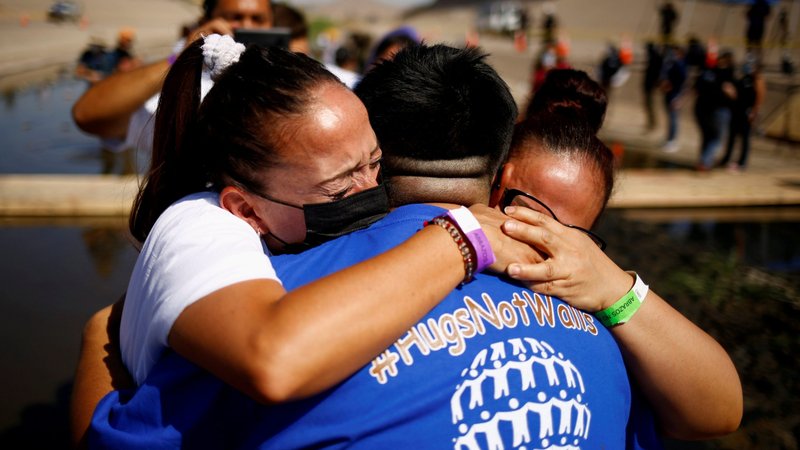 People hug each other as they participate in a reunification event named "Hugs Not Walls" on the border between Ciudad Juarez, Mexico, and El Paso, Texas, June 19, 2021. (CNS photo/Jose Luis Gonzalez, Reuters)