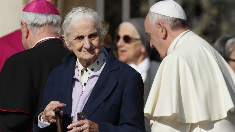 An elderly woman walks away after meeting Pope Francis in St. Peter's Square at the Vatican in this Sept. 28, 2014, file photo. The pope has chosen the theme "I am with you always," for the first World Day for Grandparents and the Elderly, to be celebrated July 25. (CNS photo/Paul Haring)