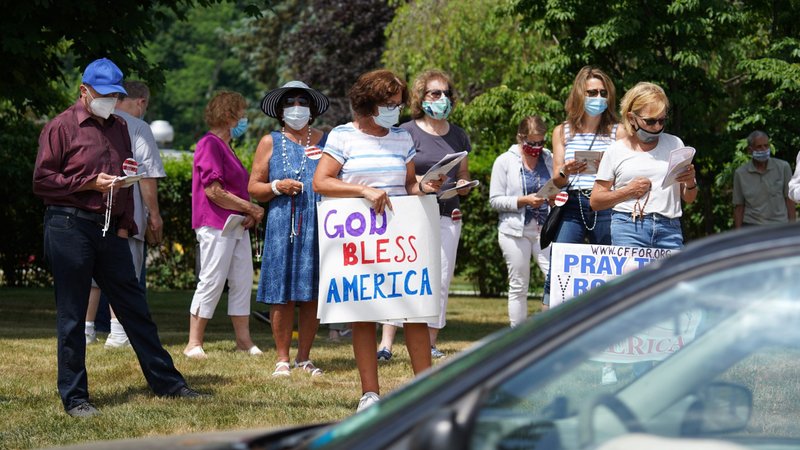 People recite the rosary while participating in a roadside prayer rally at St. James Church in Setauket, N.Y., June 24, 2020, to mark the U.S. Conference of Catholic Bishops' annual Religious Freedom Week. The observance always begins June 22, the feast of two English martyrs who fought religious persecution, Sts. Thomas More and John Fisher, and ends June 29, the feast of two apostles martyred in Rome, Sts. Peter and Paul. (CNS photo/Gregory A. Shemitz)