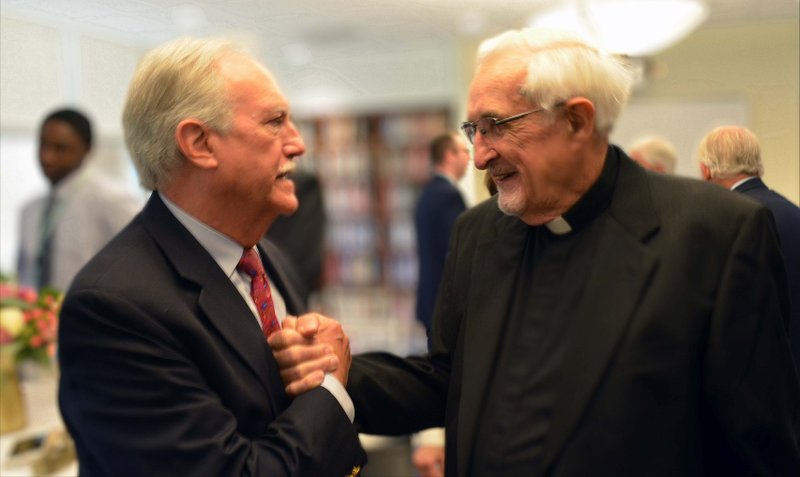 Miguel "Mike" Bezos talks with Oblate Father James P. Byrne in an undated photo. Bezos has pledged $12 million to Salesianum School in Wilmington, Del., to establish a scholarship in memory of Father Byrne, who supervised the house for immigrant Cuban boys who attended Salesianum in the early 1960s. Bezos graduated from the school in 1963. Father Byrne died in March 2020. (CNS photo/courtesy Salesianum School via The Dialog)