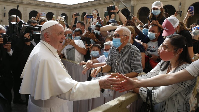 Pope Francis greets people during his general audience in the San Damaso Courtyard of the Apostolic Palace at the Vatican June 23, 2021. The pope began a new series of audience talks focused on St. Paul's Letter to the Galatians and its lessons about evangelization, faith and freedom. (CNS photo/Paul Haring)
