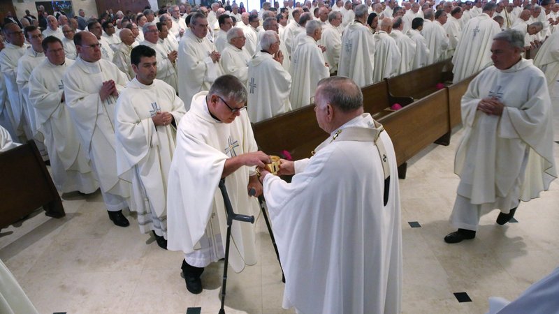 Miami Archbishop Thomas G. Wenski distributes Communion during Mass June 13, 2018, at St. Pius X Catholic Church during the U.S. Conference of Catholic Bishops' annual spring assembly in Fort Lauderdale, Fla. (CNS photo/Bob Roller)