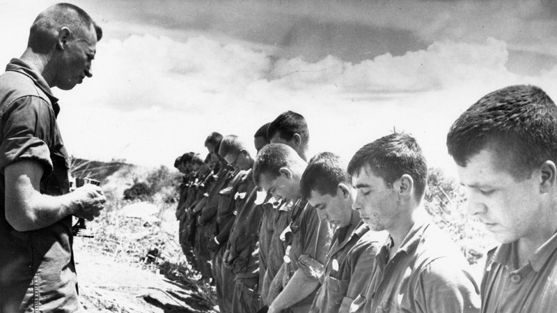 Maryknoll Father Vincent R. Capodanno, a Navy chaplain who was killed while serving with the Marines in Vietnam, is pictured ministering in the field in an undated photo. (CNS photo/courtesy Maryknoll Fathers and Brothers)