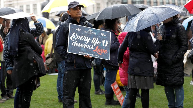 A pro-life demonstrator holds a placard during the March For Life rally in London May 11, 2019. English and Welsh Catholic bishops expressed relief after members of the House of Commons withdrew proposals to legalize abortion on demand up to birth and to make it a crime to protest outside an abortion clinic. (CNS photo/Peter Nicholls, Reuters)