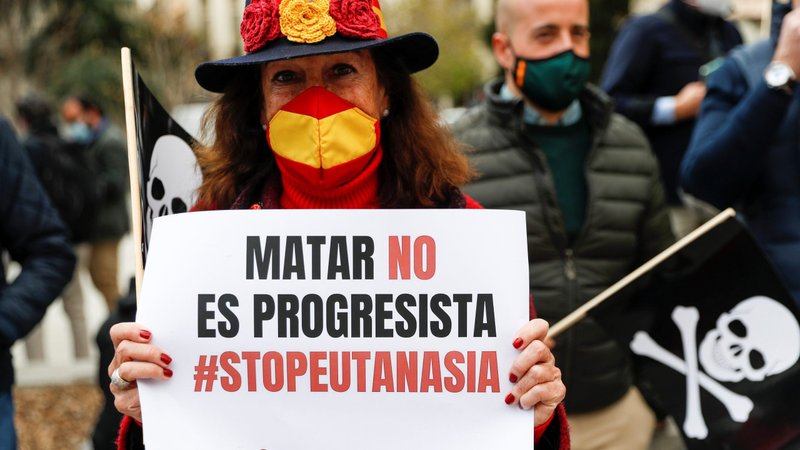 A woman holds a banner that reads "Killing is not progressive. Stop euthanasia" as she protests in Madrid March 18, 2021, against a law to legalize euthanasia in Spain. (CNS photo/Susana Vera, Reuters)