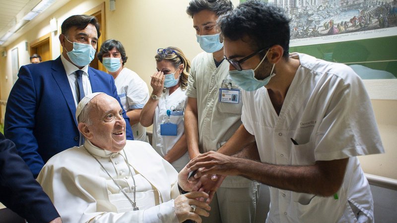 Pope Francis gives a rosary to a member of the medical staff at Gemelli hospital in Rome July 11, 2021, as he recovers following scheduled colon surgery. Earlier the pope led the Angelus from a balcony at the hospital. (CNS photo/Vatican Media via Reuters)
