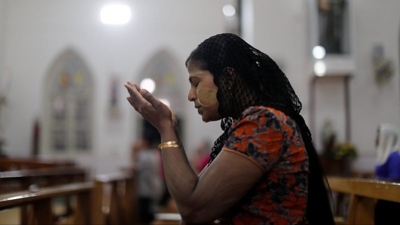 A woman is pictured in a file photo praying at St. Anthony Church in Yangon, Myanmar. Experts speaking during an International Christian Concern panel say persecution is worsening for Christians in post-coup Myanmar. (CNS photo/Jorge Silva, Reuters)