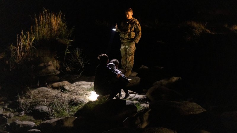 A member of the Texas Army National Guard lights the river bank for a Honduran family after they crossed the Rio Grande into Roma, Texas, May 10, 2021. U.S. Immigration and Customs Enforcement released a new policy July 9 that said it will no longer detain most pregnant, nursing and postpartum women for deportation. (CNS photo/Adrees Latif, Reuters)