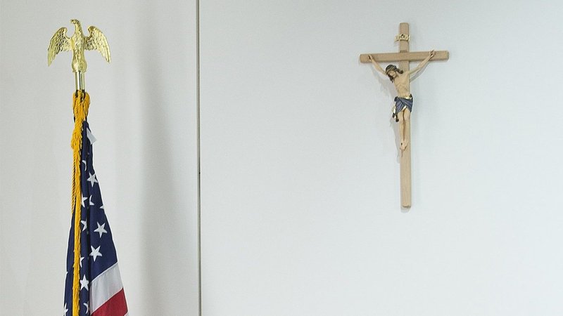 A cross and a U.S. flag are seen in this illustration photo. The 7th U.S. Circuit Court of Appeals July 9, 2021, dismissed a hostile work environment lawsuit brought against the Archdiocese of Chicago by a former parish music director. (CNS photo/Tyler Orsburn)