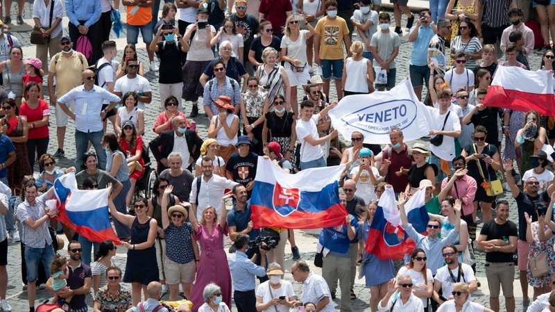 Pilgrims holding the Slovak flag cheer in St. Peter's Square at the Vatican July 4, 2021, as Pope Francis announces he will visit their country Sept. 12-15. The visit will follow after the pope celebrates the closing Mass at an International Eucharistic Congress in Budapest, Hungary. (CNS photo/Vatican Media)