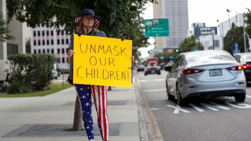 A person in Tampa, Fla. demonstrates outside a Hillsborough County School Board meeting May 18, 2021, against the school COVID-19 mask mandate. The 6th U.S. Circuit Court of Appeals heard arguments July 21, 2021, from Resurrection Catholic School in Lansing, Mich., on whether requiring Michigan students to wear masks in classrooms violates their religious freedom. (CNS photo/Octavio Jones, Reuters)