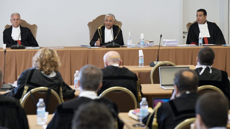 The judges of the Vatican City State criminal court -- Venerando Marano, Giuseppe Pignatone and Carlo Bonzano -- face dozens of lawyers in a makeshift Vatican courtroom July 27, 2021, as the trial of 10 defendants in a financial malfeasance case begins. Cardinal Angelo Becciu is among the defendants. (CNS photo/Vatican Media)