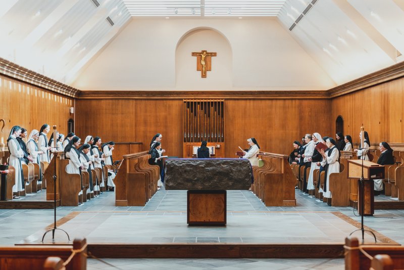 Sisters at St. Mary’s Abbey pray the Liturgy of the Hours in the convent’s main chapel. Guests are allowed to pray and attend Mass in the visitor section of the chapel. (Isabel Cacho)