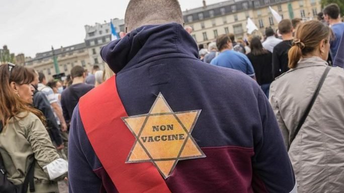 A star that reads, not vaccinated is attached on the back of an Anti-vaccine protesters during a rally in Paris, Saturday, July 17, 2021. (Michel Euler/AP via CRux)