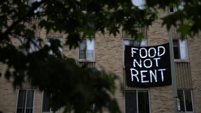 A sign made from a sheet hangs from a window of an apartment building in the Columbia Heights neighborhood in Washington May 18, 2020, about people's inability to pay rent amid the coronavirus pandemic. (CNS photo/Tom Brenner, Reuters)