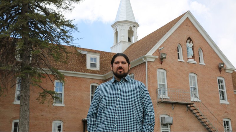 Maka Akan Najin Black Elk, a leader in Native American and Catholic education for truth, healing and reconciliation, is seen in front of the Red Cloud Indian School in Pine Ridge, S.D., May 5, 2021. He was selected July 29 as the recipient of FADICA's 2021 Distinguished Catholic Leadership Award. (CNS photo/Marcus Fast Wolf, courtesy Red Cloud Indian School)