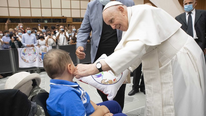Pope Francis gets a young person during his general audience in Paul VI hall at the Vatican Aug. 4, 2021. It was his first audience since undergoing colon surgery July 4. (CNS photo/Vatican Media)