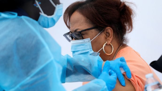 A local resident receives a dose of the Pfizer-BioNTech COVID-19 vaccine during a vaccination event for adolescents and adults outside the Bronx Writing Academy school in New York City June 4, 2021. (Mike Segar/CNS, Reuters, via Crux)